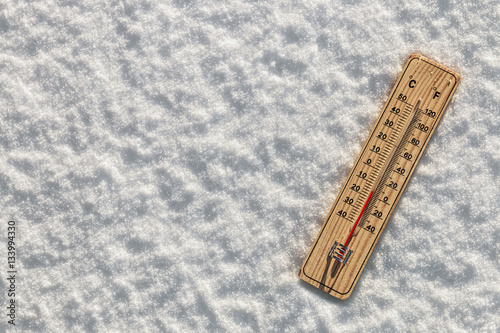 Wooden Thermometer in the snow with freezing temperatures