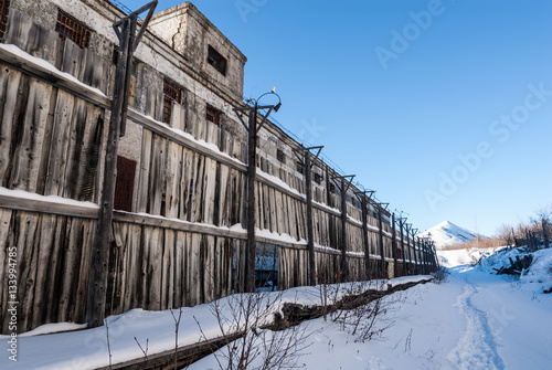 Wooden fence of abandoned prison photo