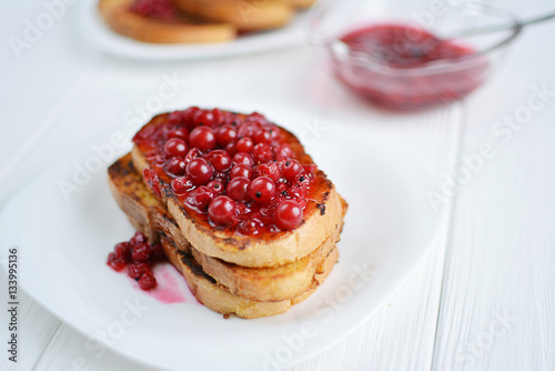 Homemade bread toast with berry jam on a white background