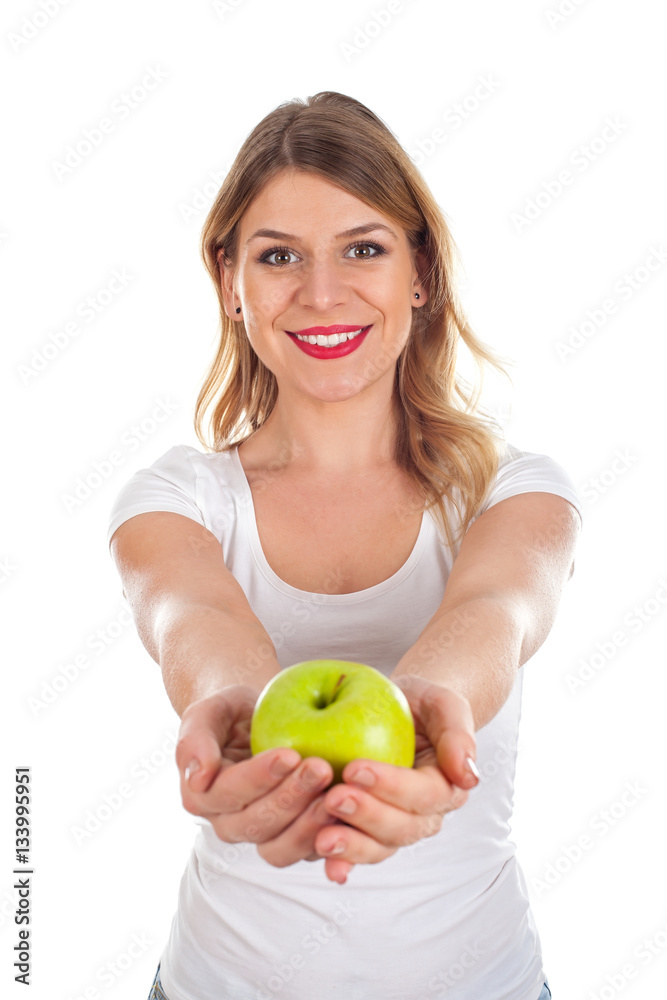 Smiling young woman holding a green apple Smiling young woman holding a green apple