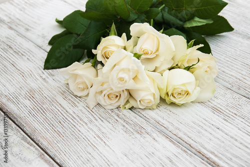 White roses on a wooden table