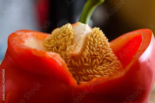 Fotografi Seeds inside an opened red bell pepper.