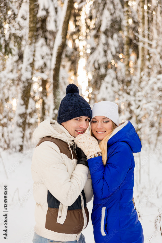 The guy and the girl have a rest in the winter woods. The guy and the girl have a rest in the winter woods.