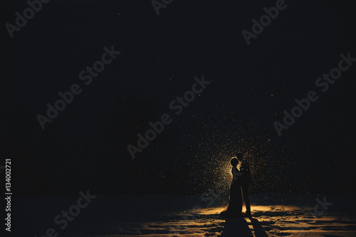 Silhouettes in the snow at night. People photo