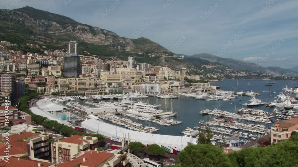 Pan across an elevated view over the the port of Monte Carlo in Monaco. Cruise ships are anchored in the bay Pan across an elevated view over the the port of Monte Carlo in Monaco. Cruise ships are anchored in the bay