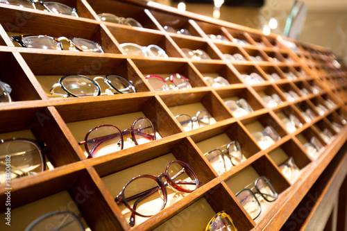 eyeglasses in wooden rack