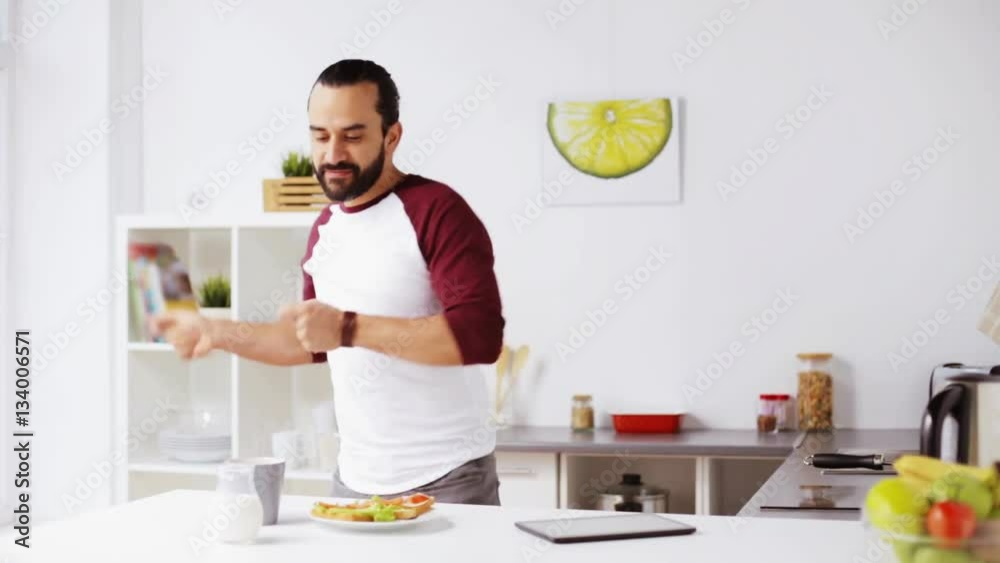 man eating breakfast and dancing at home man eating breakfast and dancing at home