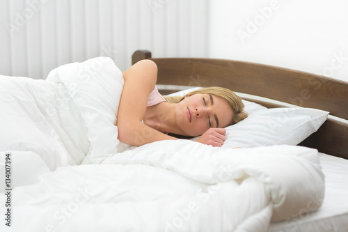 The beautiful woman sleeping on the bed