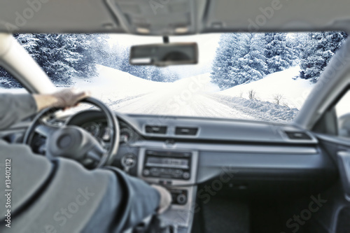 Fototapeta Naklejka Na Ścianę i Meble -  car interior with driver and winter road 