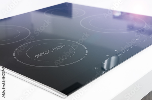 Modern black induction cooker on white countertop