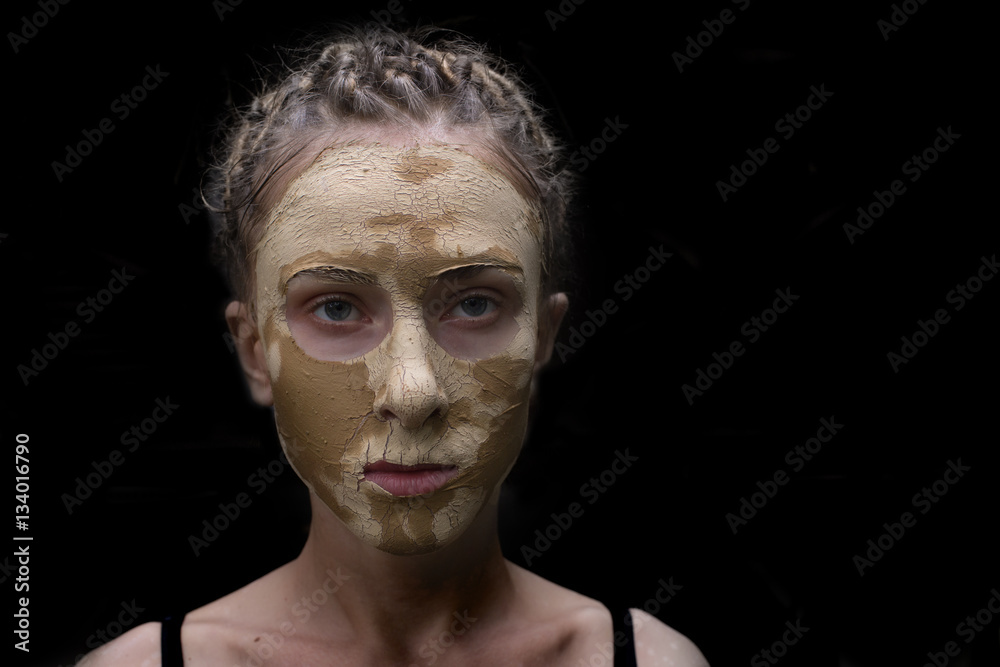 Obraz premium woman with facial mask,isolated on black