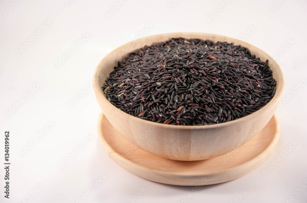 The Organic rice in wooden bowl. The purple rice organic in wooden bowl. The Organic rice in wooden bowl. The purple rice organic in wooden bowl.