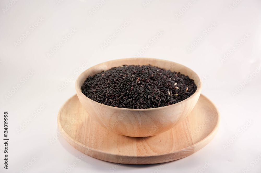 The Organic rice in wooden bowl. The purple rice organic in wooden bowl. The Organic rice in wooden bowl. The purple rice organic in wooden bowl.