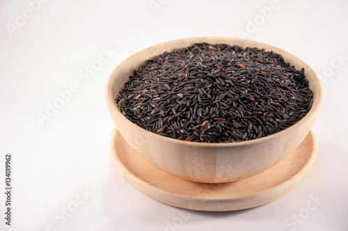 The Organic rice in wooden bowl. The purple rice organic in wooden bowl.
