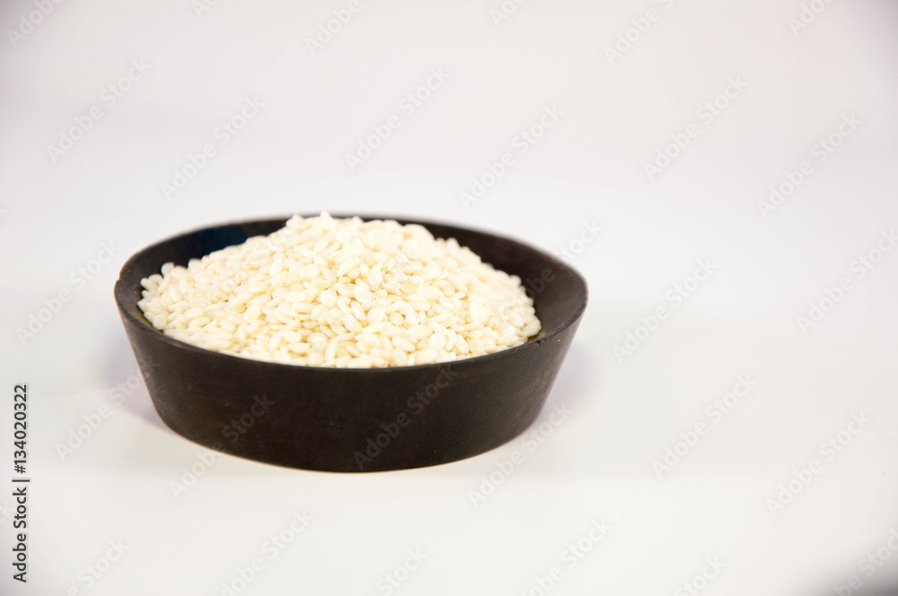 The sesame in wooden bowl. white sesame. The sesame in wooden bowl. white sesame.
