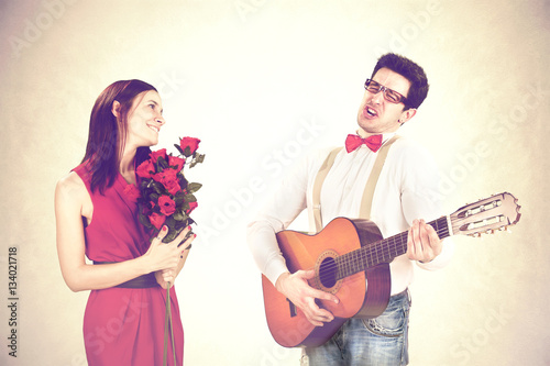 Fotografija cool guy winning His Woman with a sweet serenade in a valentine's day