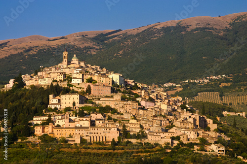City on a hill in Italy at sunset.