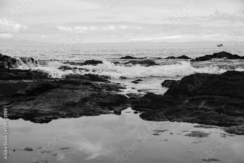 Black and white image of tide running over rocks