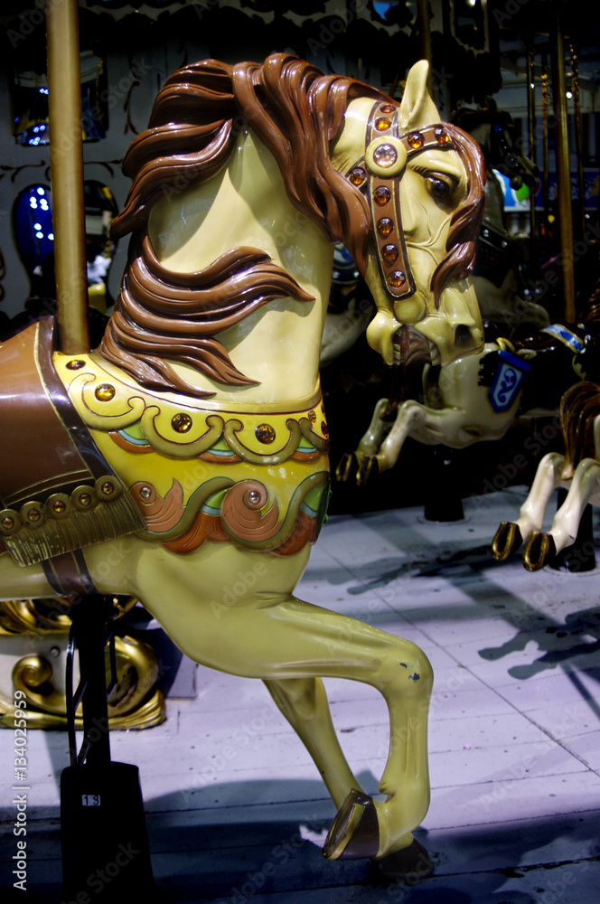 Brown carousel horse on merry-go-round
