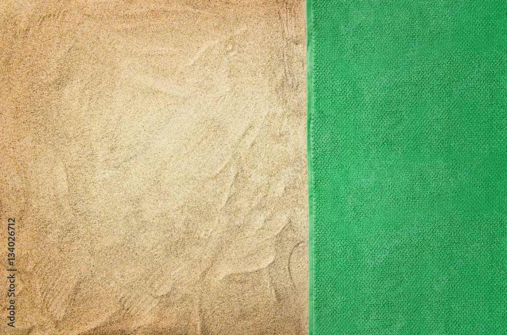 Fototapeta premium Top view of sandy beach with towel frame. Background with copy space and visible sand texture.