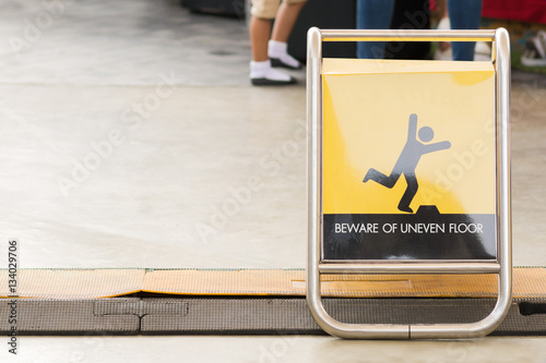 Close up slip warning sign on the ground.