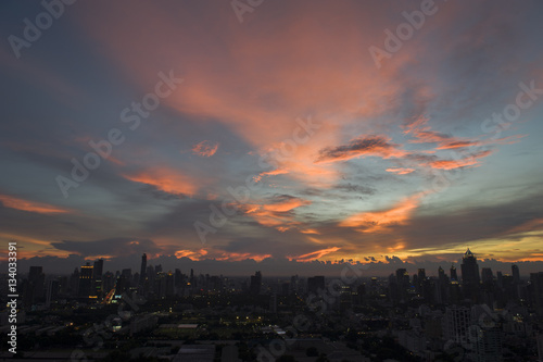 Colorful blue sky red cloud on twilight over city with silhouette building foreground
