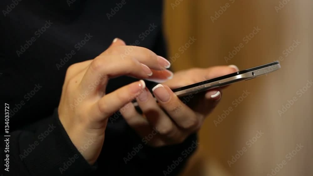 woman uses a mobile phone. Hands close-up woman uses a mobile phone. Hands close-up