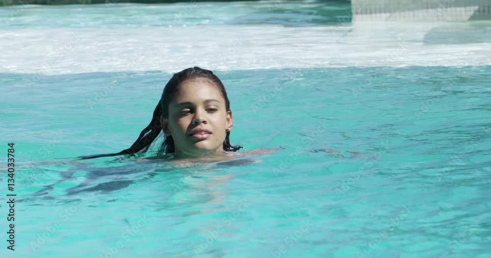 Beautiful woman swimming in swimming pool Beautiful woman swimming in swimming pool