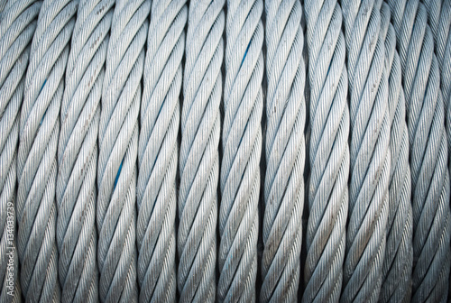 A shot of a roll of industrial steel cable. Heavy duty steel wire cable or rope as background