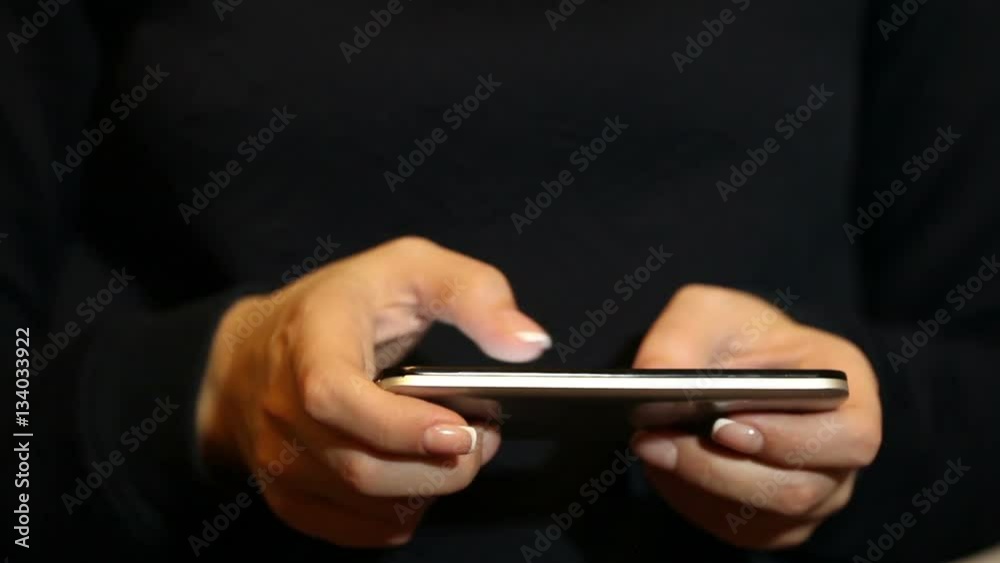 woman uses a mobile phone. Hands close-up woman uses a mobile phone. Hands close-up