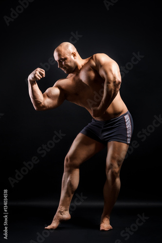Bodybuilder Topless Over Black Background