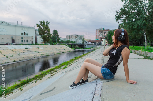 Asian girl listening to music with headphones photo