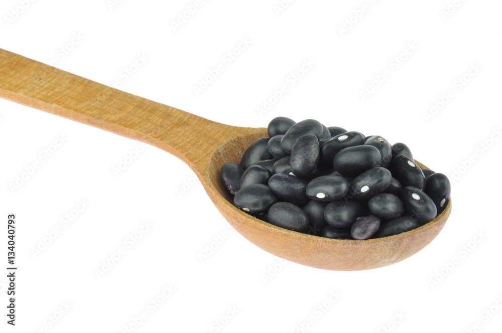 Black beans in wooden spoon