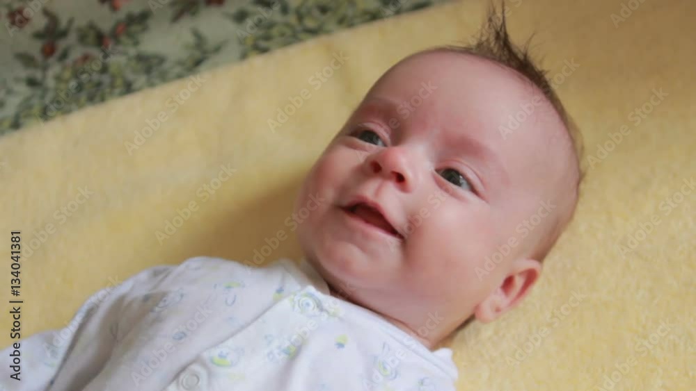 Small child with expressive eyes smiles sweetly Small child with expressive eyes smiles sweetly