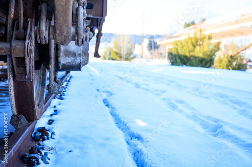 Train closeup on snowy railroad tracks © viperagp