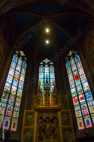 Altar and stained glass in St Vitus Cathedral in Prague