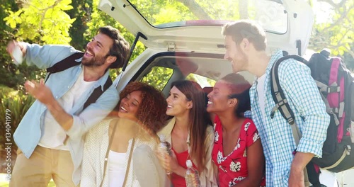 Group of friends taking a selfie from trunk of car