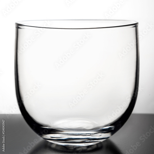 Glass transparent goblet on a light background