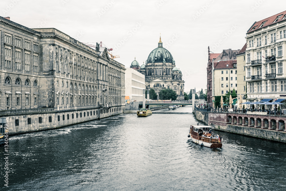 The Spree with ships and the Berlin Cathedral on the Museumsinsel in Berlin, Germany