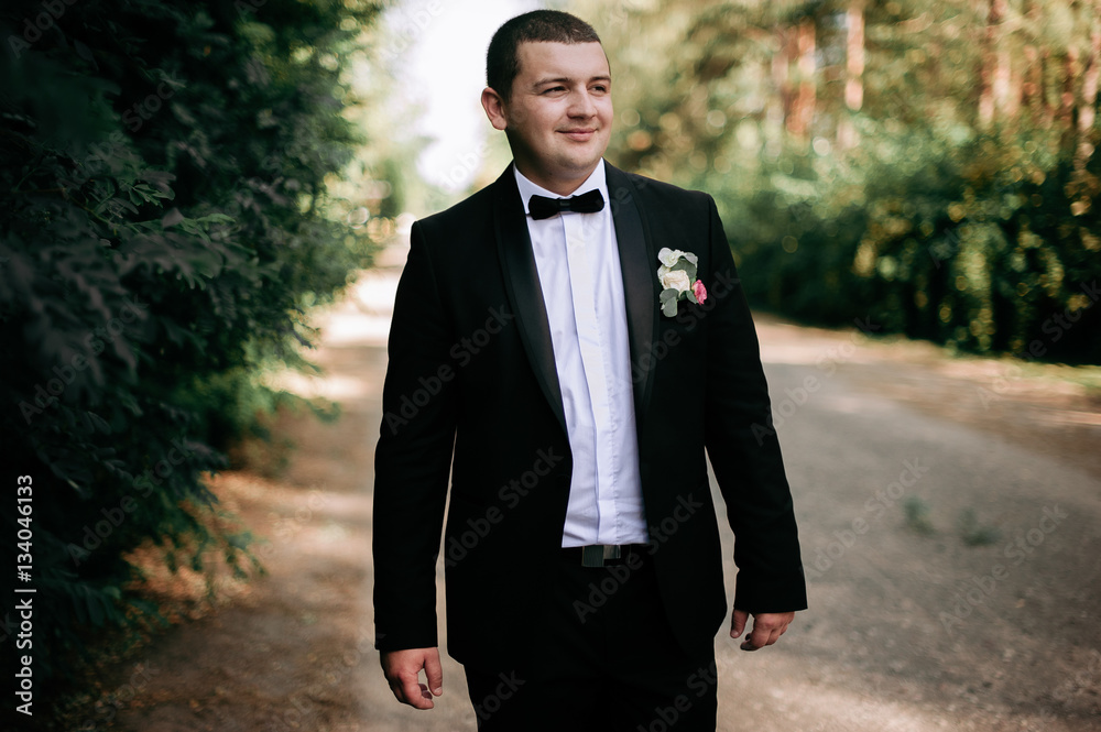 wedding day. Groom is staying and waking wearing black classic c wedding day. Groom is staying and waking wearing black classic c