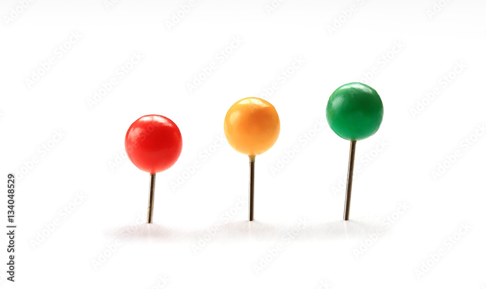 set of colorful stationery pins stuck in a white isolated background set of colorful stationery pins stuck in a white isolated background