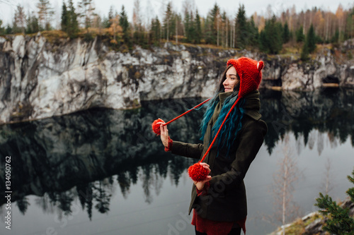 Pretty nice girl enjoy beautiful lake view from the hilltopl and good weather in Karelia. Around the rocks. photo