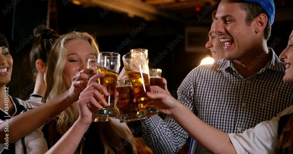 Group of friends watching tv in bar Group of friends watching tv in bar