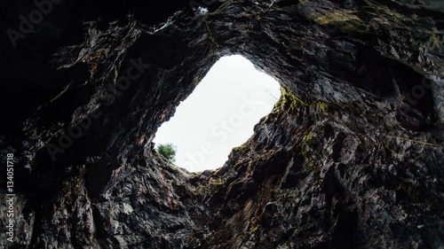 Look at the sky through the hole in the cave
