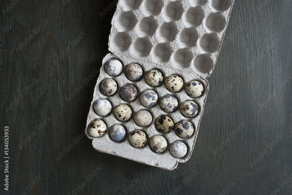Quail eggs in a cardboard box. Eco-product in environmentally fr Quail eggs in a cardboard box. Eco-product in environmentally fr