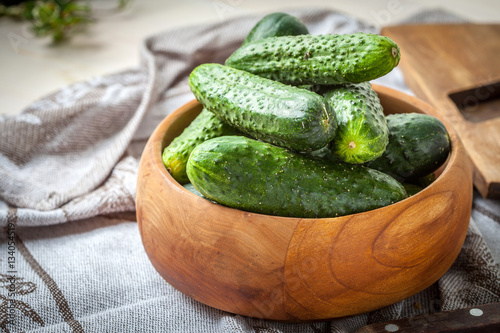 Fresh cucumbers in a wooden bowl.