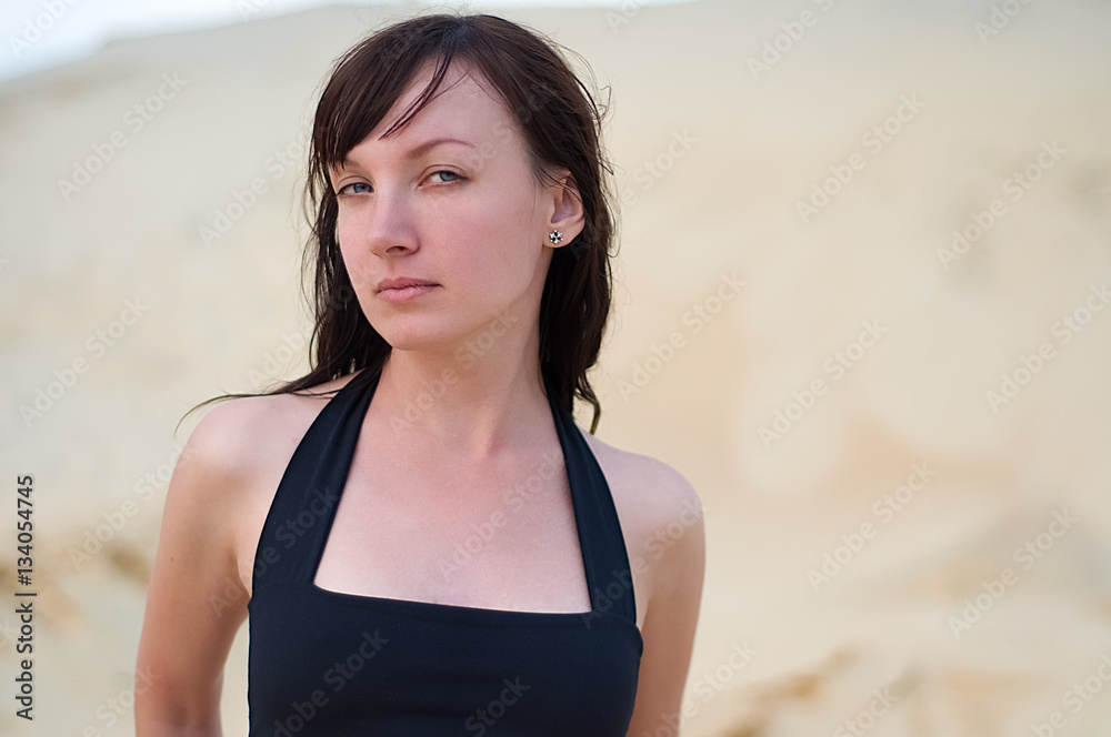 Young woman outdoor portriat. Girl at beach looking at camera. Young woman outdoor portriat. Girl at beach looking at camera.