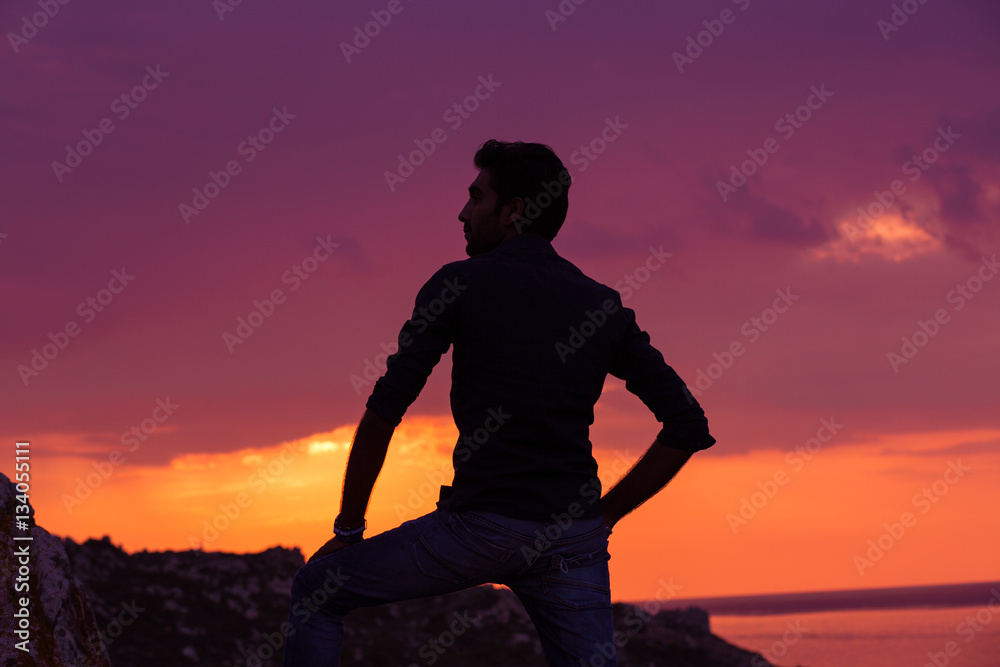 man standing thinking back light sunset lighting side view profile silhouette summer evening beach