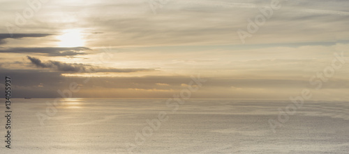 Clouds sky and sunlight sunset on horizon ocean. People on background seascape dramatic atmosphere rays sunrise. Relax view waves water sea, mockup nature evening concept perspective ocean sunrise