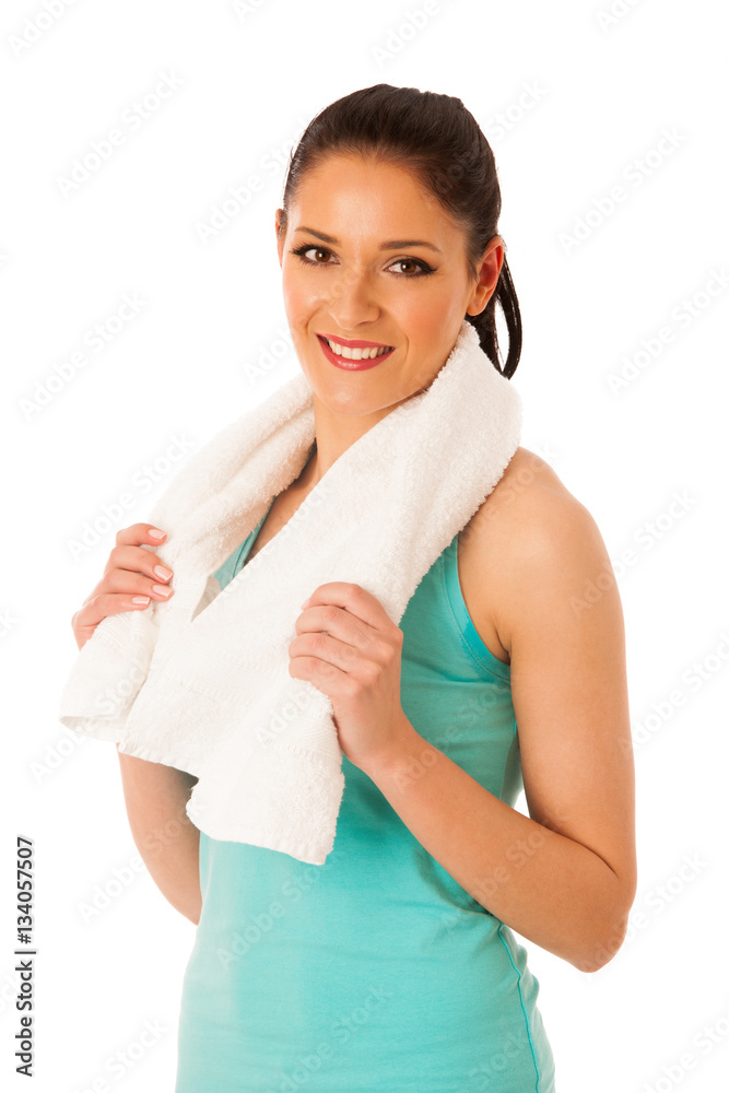 Woman rests after fitness workout with towel around her neck iso Woman rests after fitness workout with towel around her neck iso